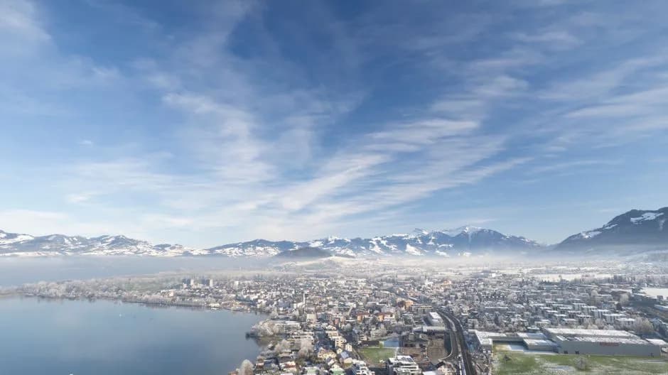 Stunning aerial view of Altendorf in Schwyz, Switzerland, with the snow-covered Swiss Alps.