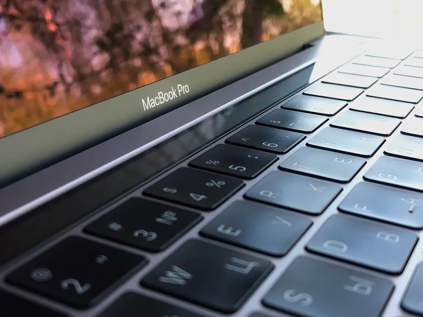 A detailed close-up of a MacBook Pro keyboard, highlighting keys and reflection.