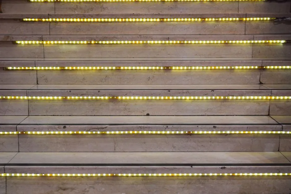 Close-up of a staircase with glowing LED lights on each step, creating a modern look.