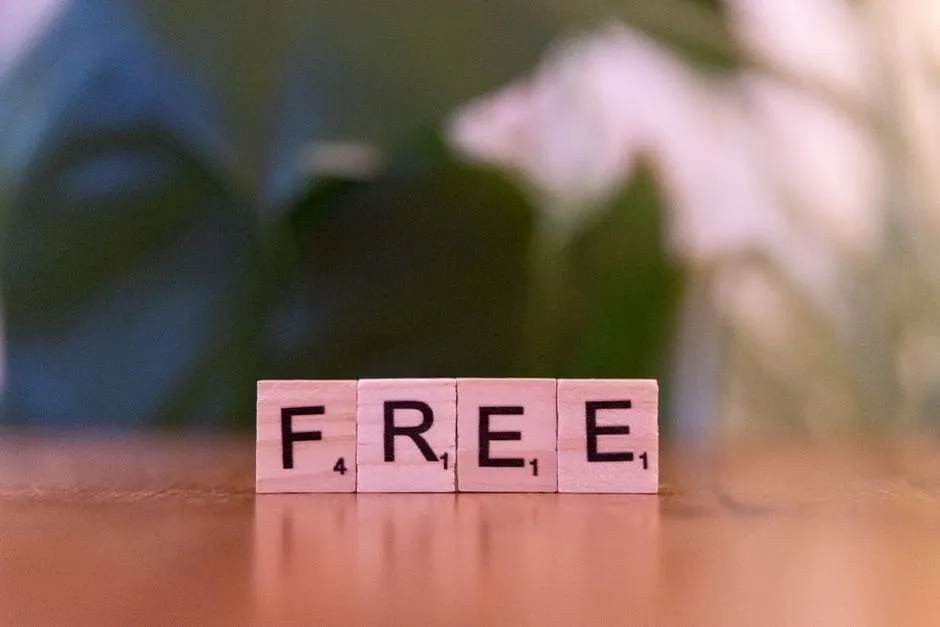 Close-up of wooden Scrabble tiles spelling 'FREE' on a table.