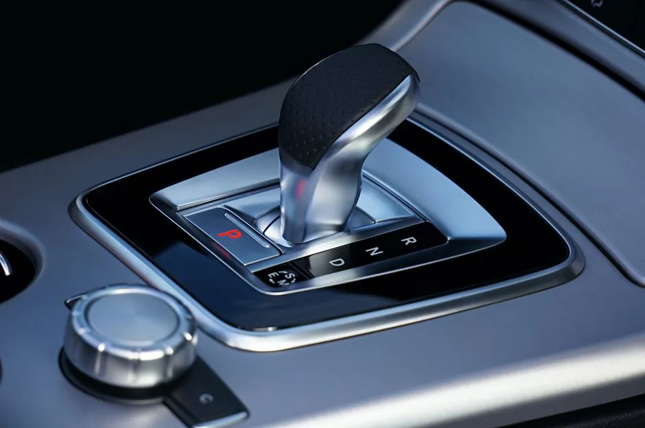 Detailed view of a sleek automatic gear shift in a luxury vehicle, emphasizing modern design.