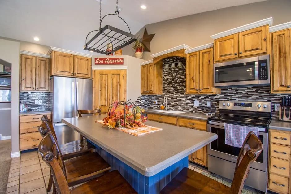 Warm and inviting rustic kitchen featuring wooden cabinets and modern appliances.