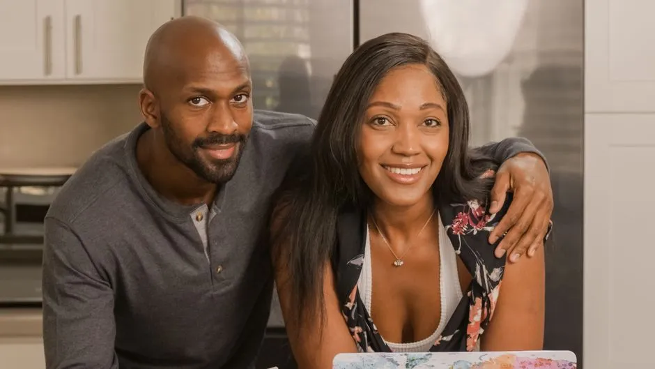 A smiling couple enjoying a moment together in their modern kitchen.