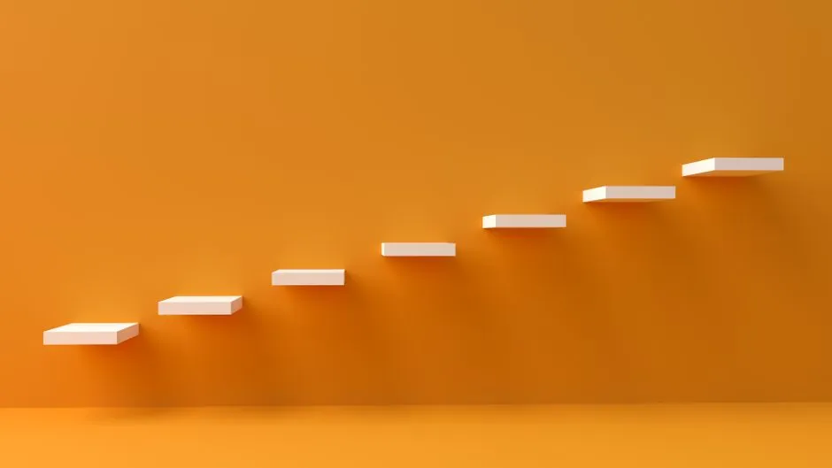White floating steps on vibrant orange wall create a minimalist and conceptual design.