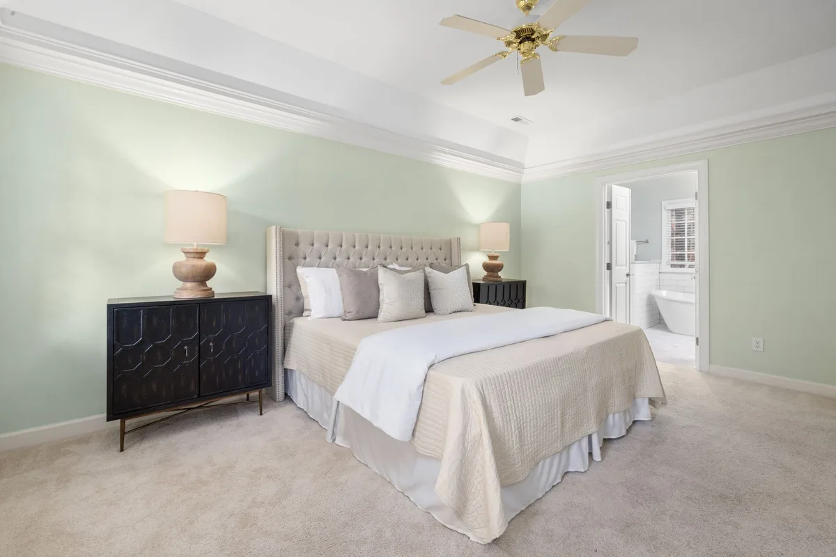 Master bedroom with a king bed, two nightstands and open walkways around the bed